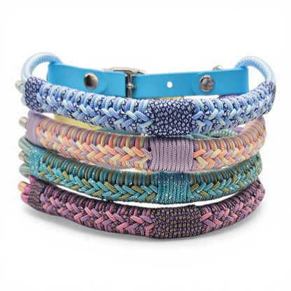 Stack of colorful braided dog collars on a white background