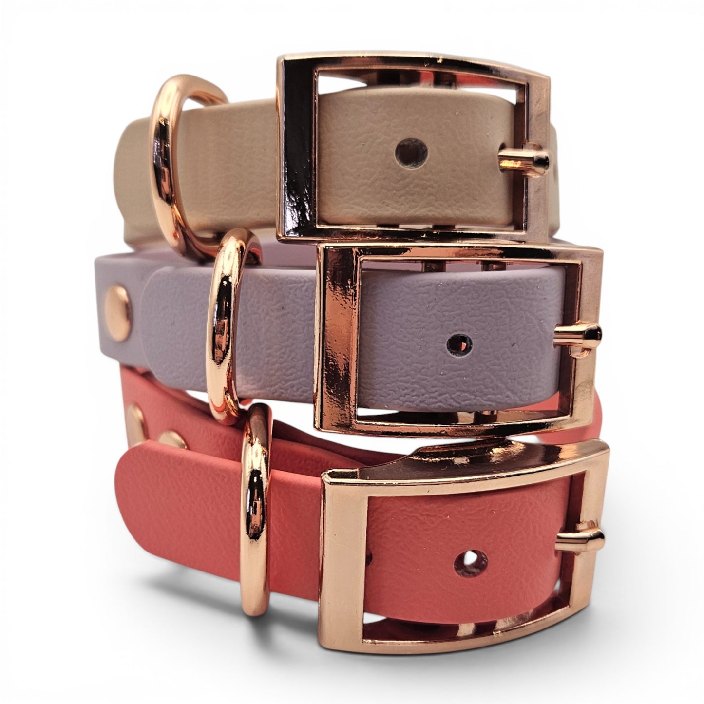Stack of pink, purple, and red  waterproof adjustable biothane dog collar with rose gold buckles on a white background