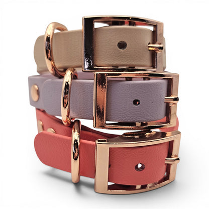 Stack of pink, purple, and red  waterproof adjustable biothane dog collar with rose gold buckles on a white background