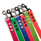 Ponies and Pups BioThane dog leads in pink, green, blue, and orange with silver and black hardware.