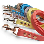Handmade waterproof BioThane dog leads, made to order in 21+ colours and three widths (shown in coral, yellow, lilac, blue, teal and beige).