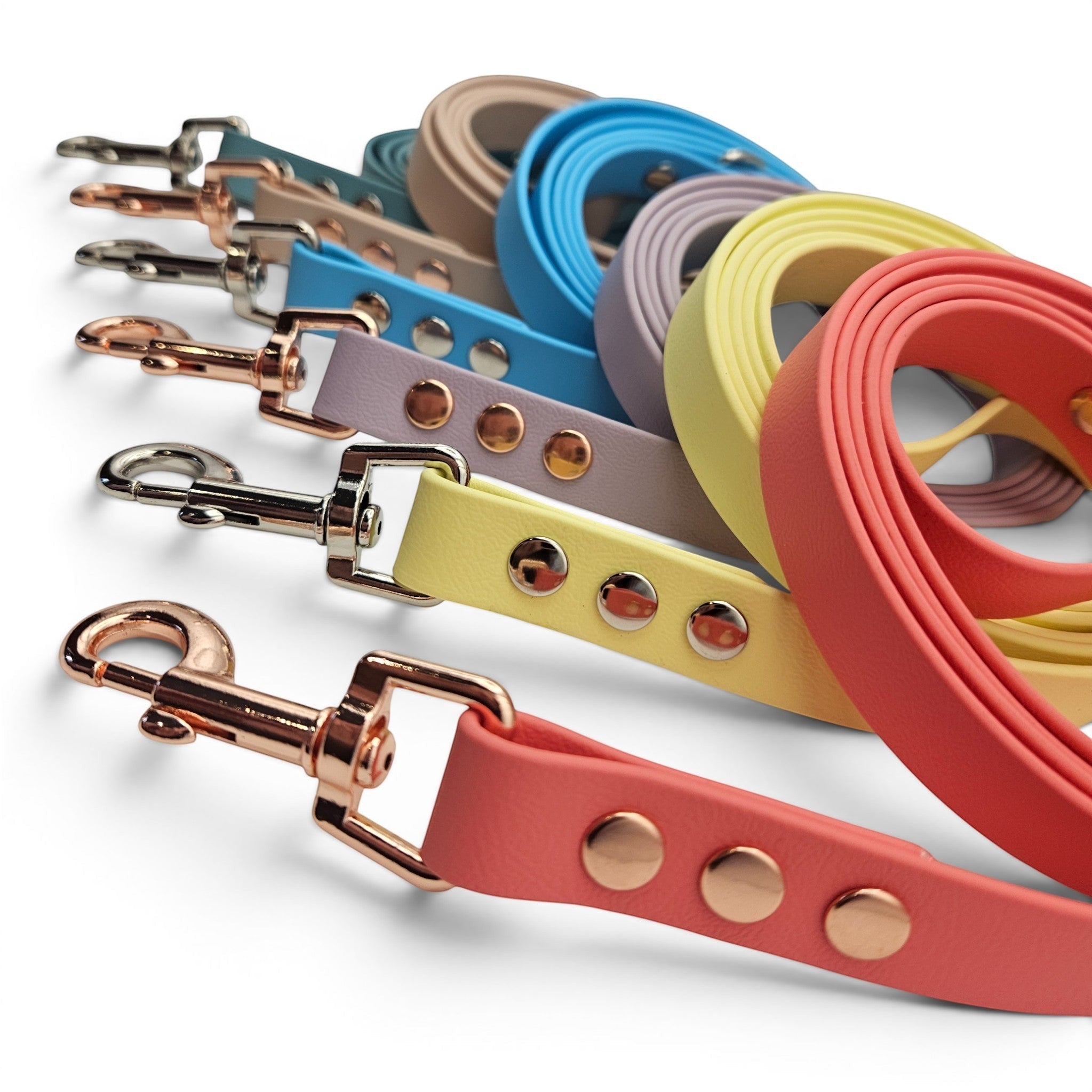 Handmade waterproof BioThane dog leads, made to order in 21+ colours and three widths (shown in coral, yellow, lilac, blue, teal and beige).