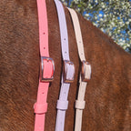 Ponies and Pups BioThane adjustable neck straps in pink, lilac, and cream with rose gold buckles on a horse.