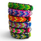 Handmade braided paracord dog collars with a BioThane base, made to order in 21+ curated colourways (shown in a range of bright colours).