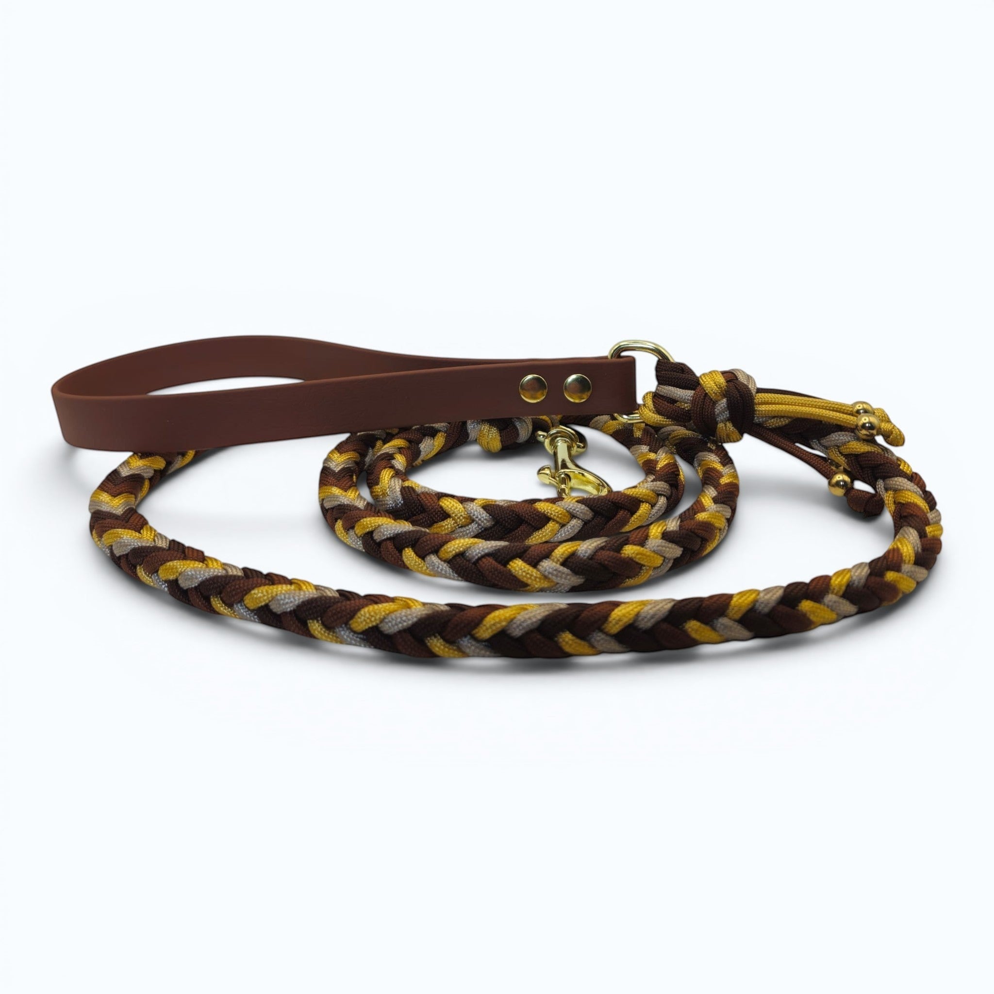 Ponies and Pups handmade braided dog lead in brown, tan, and yellow paracord with a brown BioThane handle and brass snap hook.