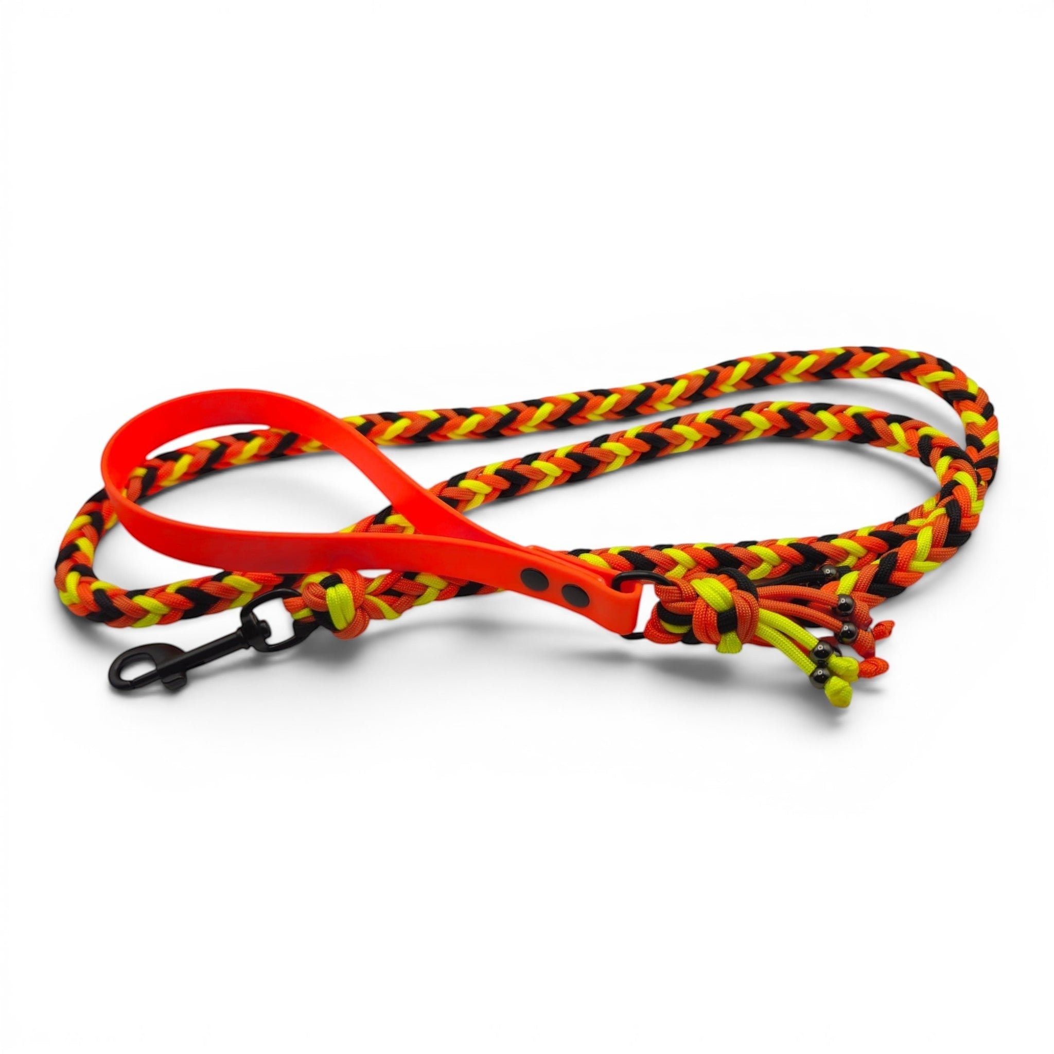 Ponies and Pups handmade braided dog lead in orange, yellow, and black paracord with a BioThane handle and metal snap hook.