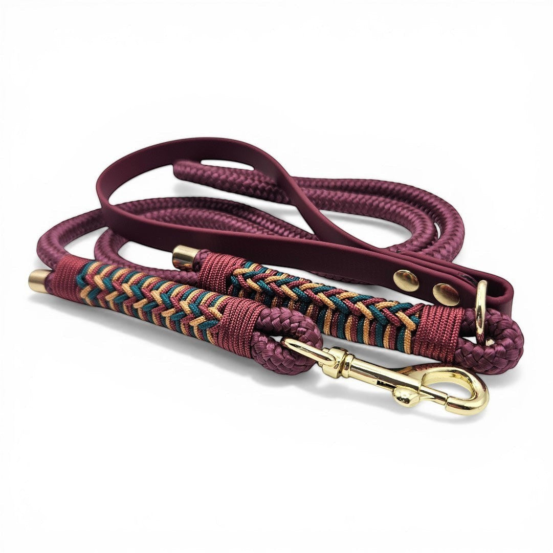Ponies and Pups Firle dog lead in burgundy with braided herringbone detail and gold hardware. Features BioThane handle and PPM rope.