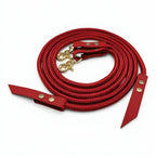 Ponies and Pups red rope and BioThane split reins with gold swivel clips and Chicago screw fixings on a white background