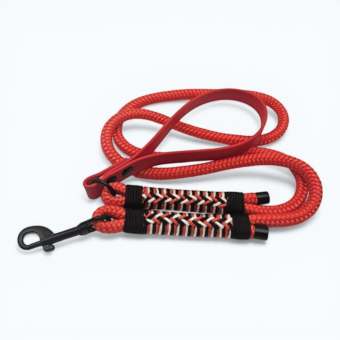 Ponies and Pups red weatherproof BioThane and braided PPM rope dog lead with herringbone paracord detail and black snap hook.